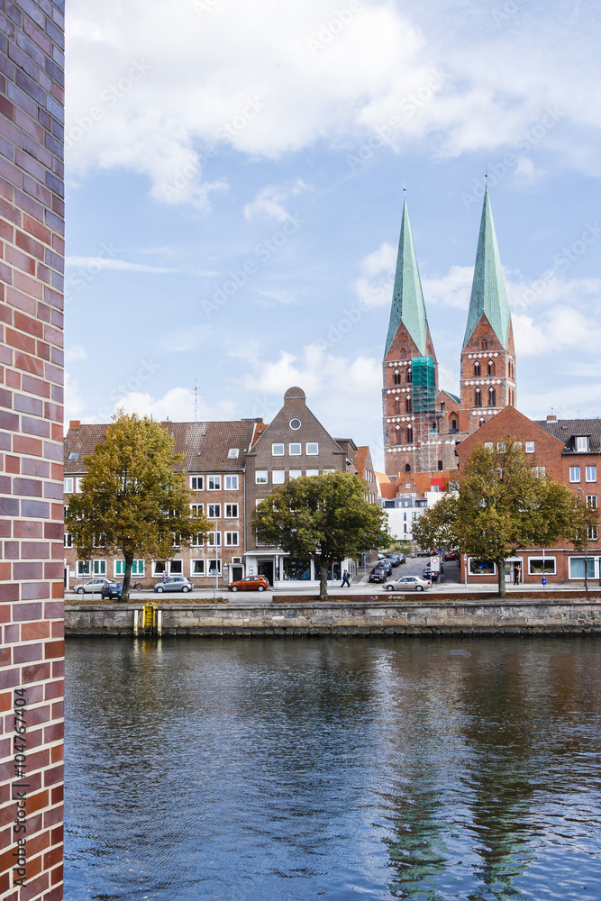 Lübeck, Germany. View of the embankment and the Gothic cathedral across the river Trave.
