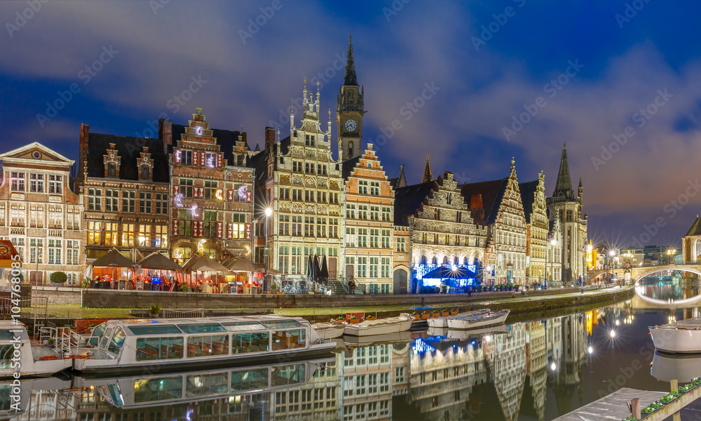 Picturesque medieval building and St Michael's Bridge on the quay Graslei in Leie river at Ghent town at evening, Belgium