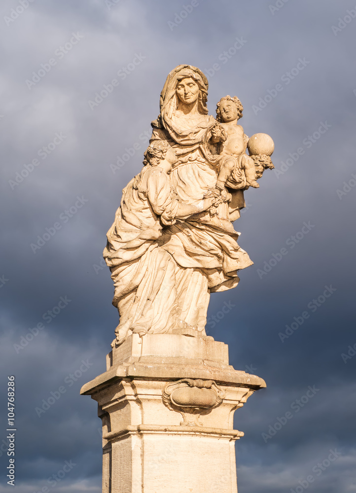 St. Anne holds blessed little Jesus and Virgin Mary. Statues on the Charles Bridge in Prague, Czech St. Anne holds blessed little Jesus and Virgin Mary. Statues on the Charles Bridge in Prague, Czech
