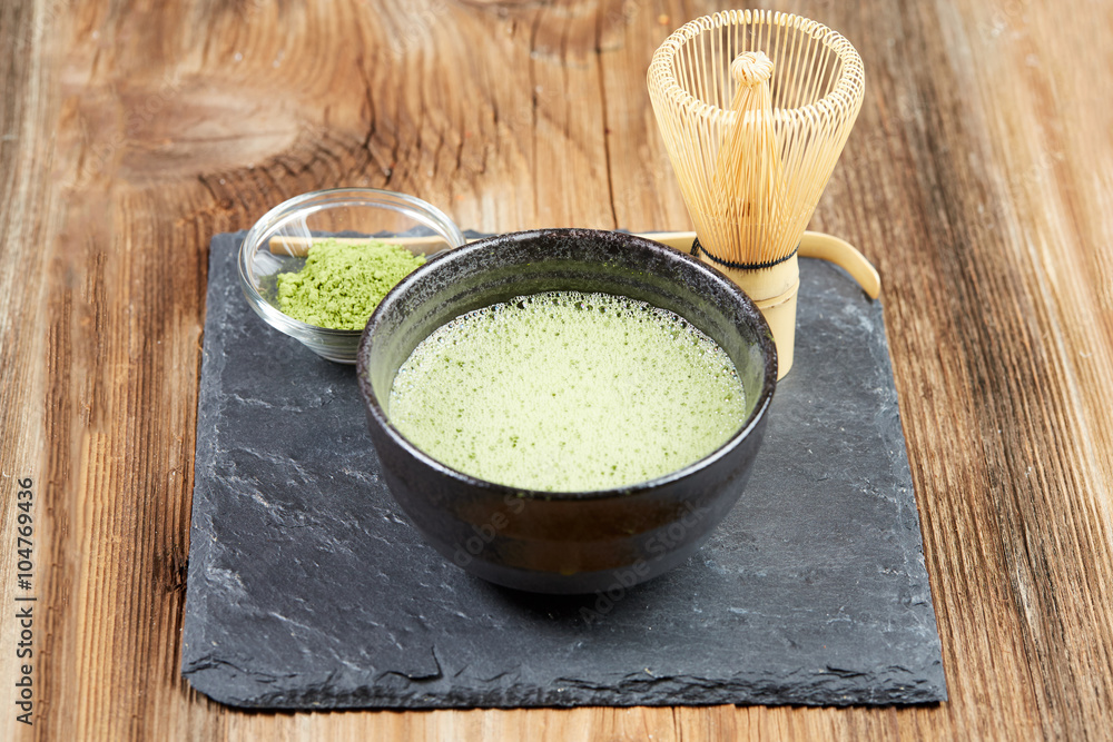 Green matcha tea on a wooden table Green matcha tea on a wooden table