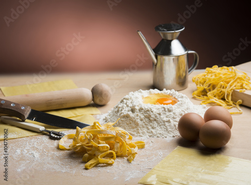 raw egg pasta with flour and rolling pin