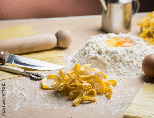 raw egg pasta with flour and rolling pin