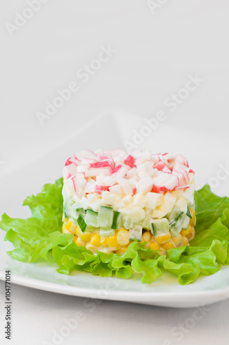 Crab sticks salad on white tablecloth