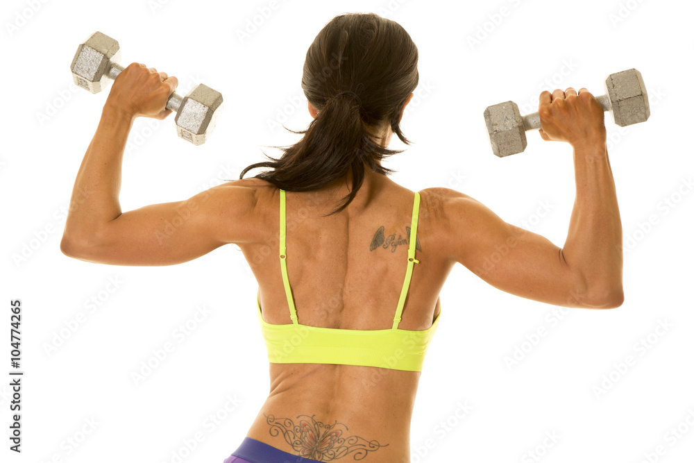 woman in green sports bra and purple shorts back close flex woman in green sports bra and purple shorts back close flex