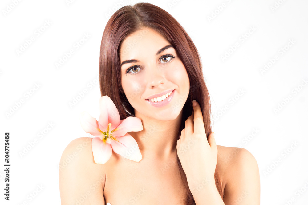 Beautiful spa woman touching her hair. Woman with pink flower smiling with white teeth. Woman with fresh and clear skin. Beautiful spa woman touching her hair. Woman with pink flower smiling with white teeth. Woman with fresh and clear skin.