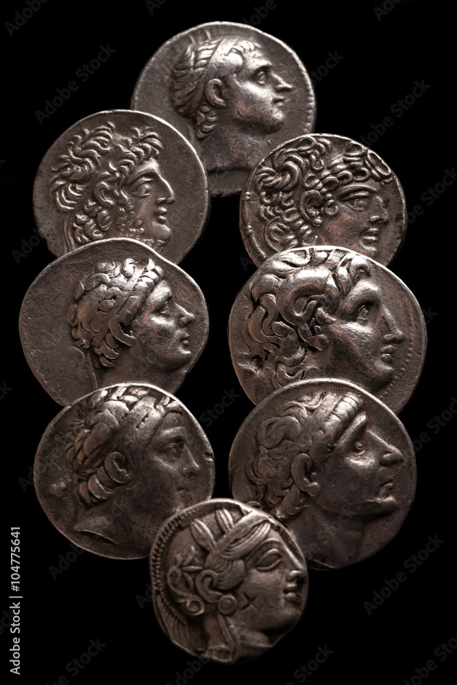Collection of ancient greek coins on a black background