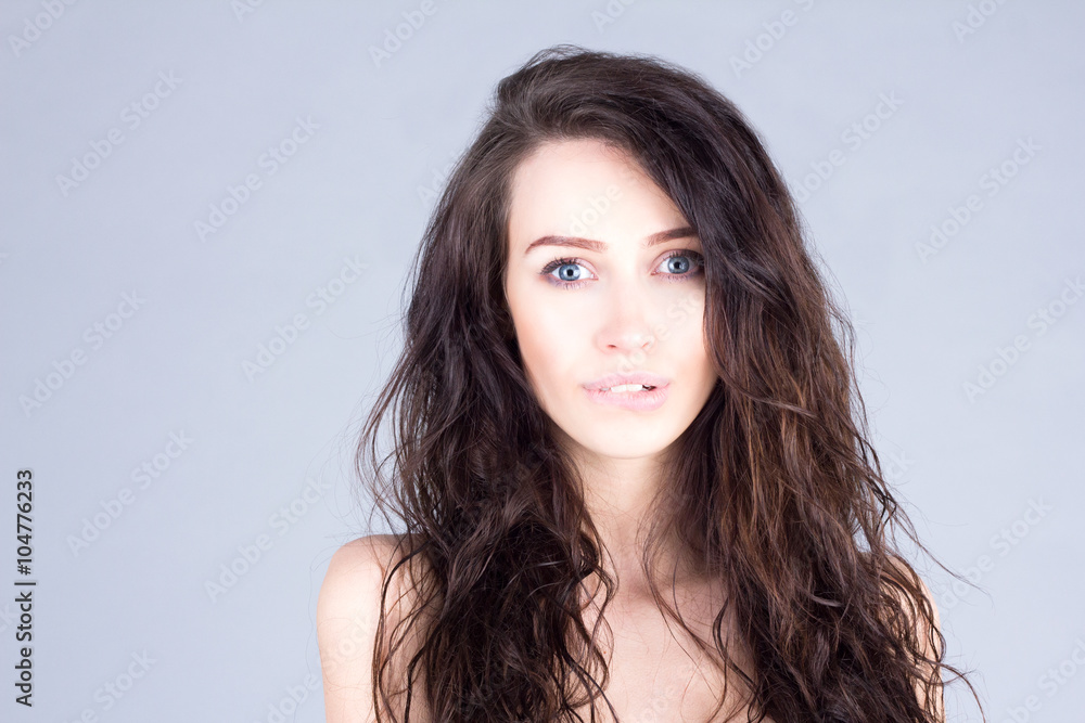 sensual woman with brown curly hair and big blue eyes biting lip. Beauty woman.
