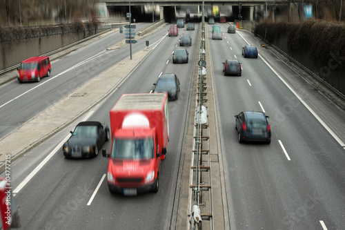 Cars on a Highway.Vehicle traffic on a busy city road in perspective. © devnenski