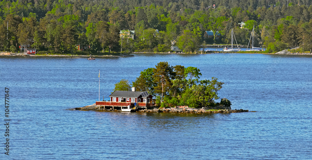 Red ochre wooden cabin on island