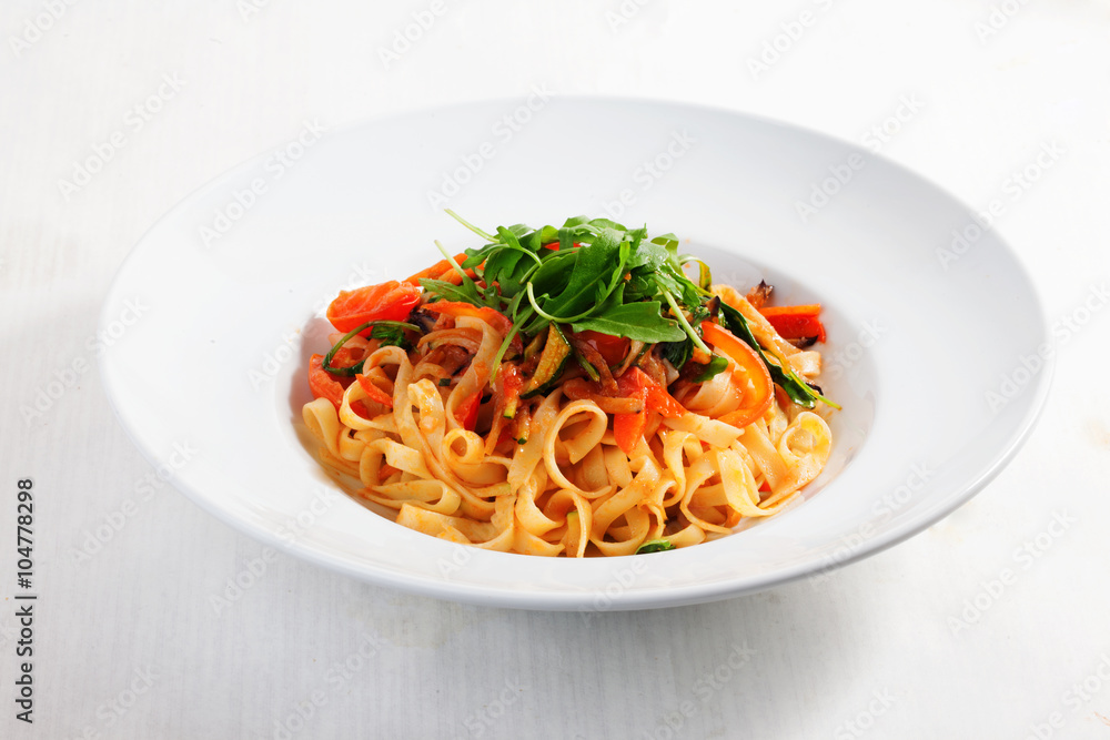 pasta with vegetables, tomatoes, zucchini, peppers, isolated on white background tomato sauce Round plate menu pasta with vegetables, tomatoes, zucchini, peppers, isolated on white background tomato sauce Round plate menu