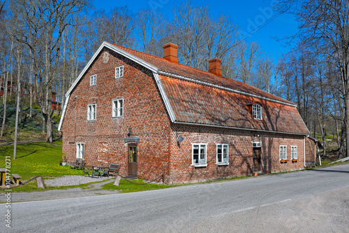 Old red brick building with a red tile roof