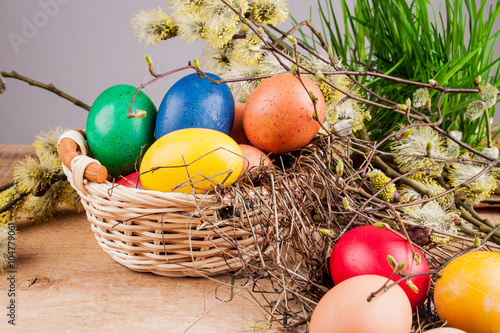 Easter eggs in the basket on a wooden table