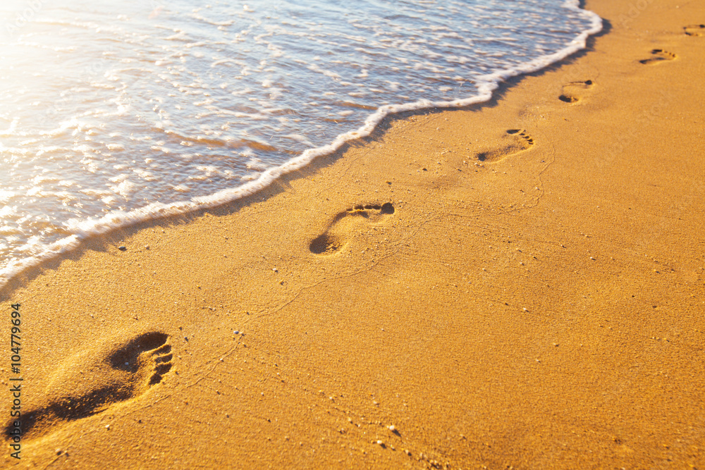 beach, wave and footprints at sunset time beach, wave and footprints at sunset time