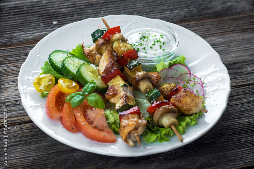 Chicken and vegetable skewers with garlic dip and salad Chicken and vegetable skewers with garlic dip and salad
