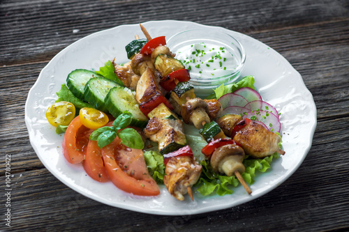 Chicken and vegetable skewers with garlic dip and salad
