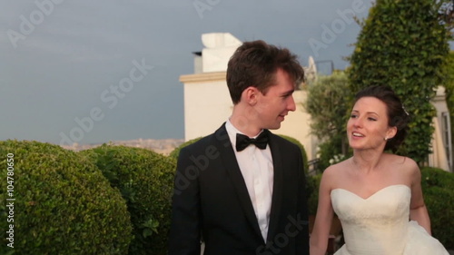 Beautiful wedding couple walking and holding hands on Elysian Fields photo