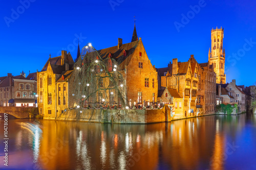 Scenic panorama with medieval fairytale town and tower Belfort from the quay Rosary, Rozenhoedkaai, in the evening, Bruges, Belgium
