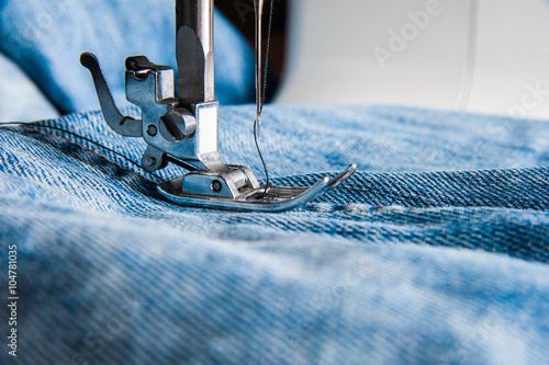 Sewing machine and blue jeans fabric.