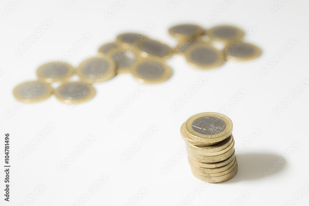 One euro coins on a pile and on a white background One euro coins on a pile and on a white background