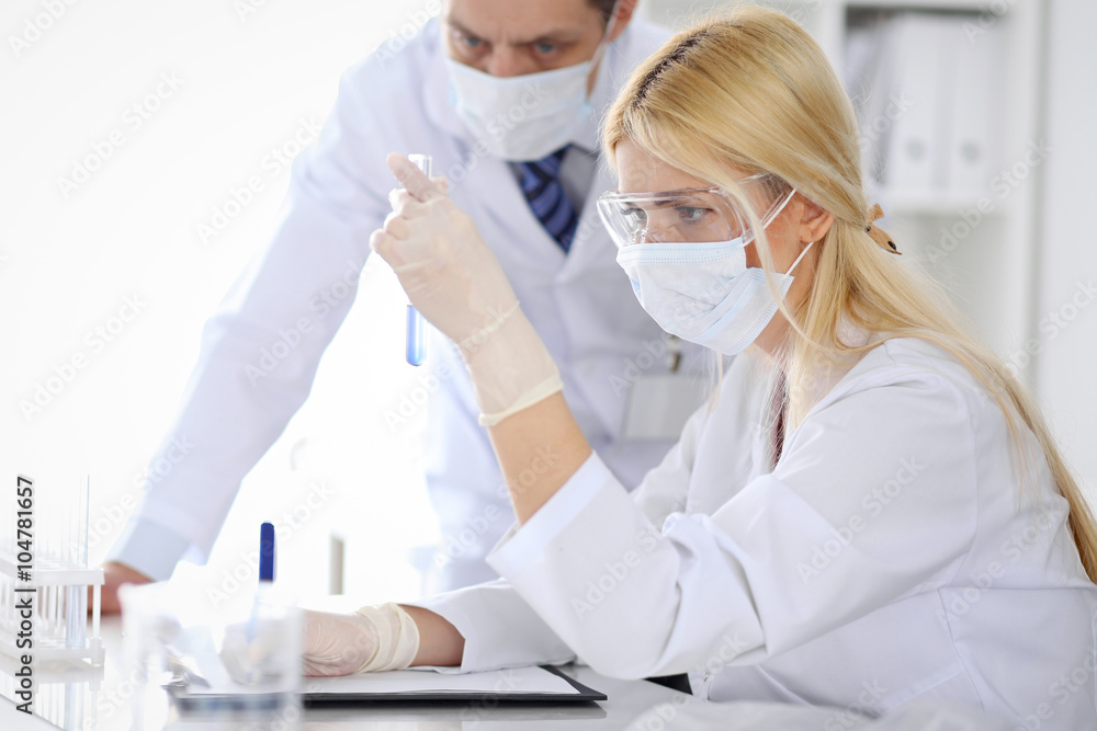 Scientific research team with clear solution in laboratory Scientific research team with clear solution in laboratory