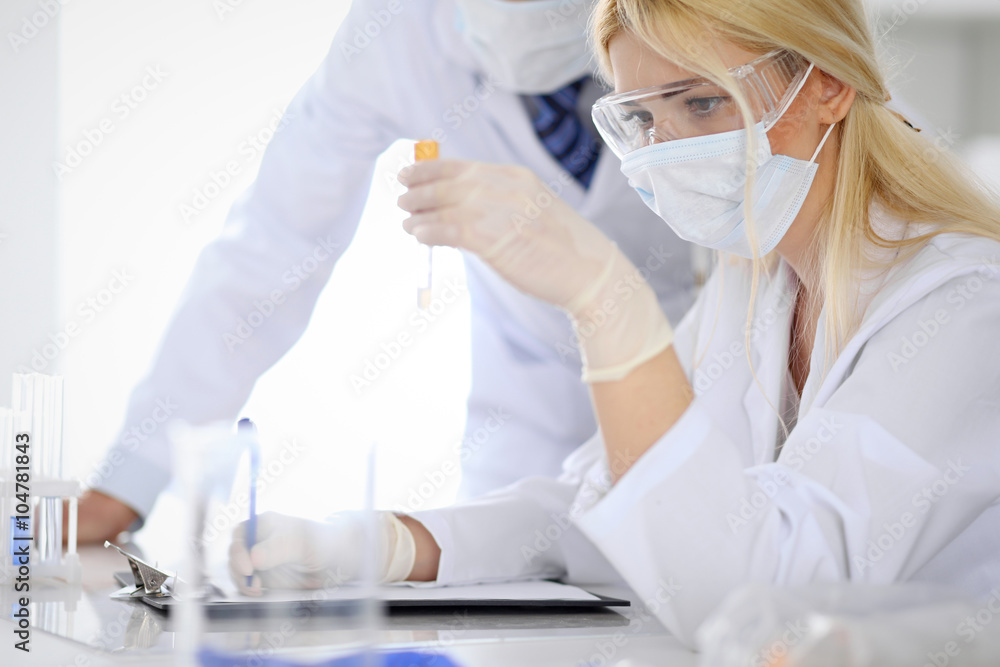 Scientific research team with clear solution in laboratory Scientific research team with clear solution in laboratory