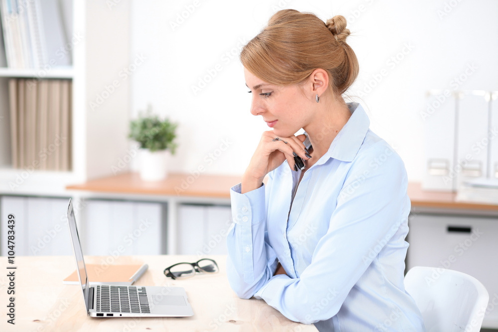 Young blonde business woman with laptop in the office. Business concept. Young blonde business woman with laptop in the office. Business concept.