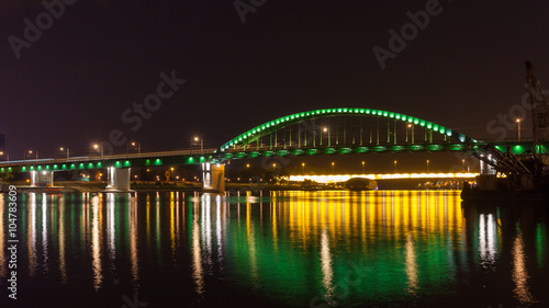 Old Tram bridge across the Sava river in Belgrade shot at night © pozdeevvs