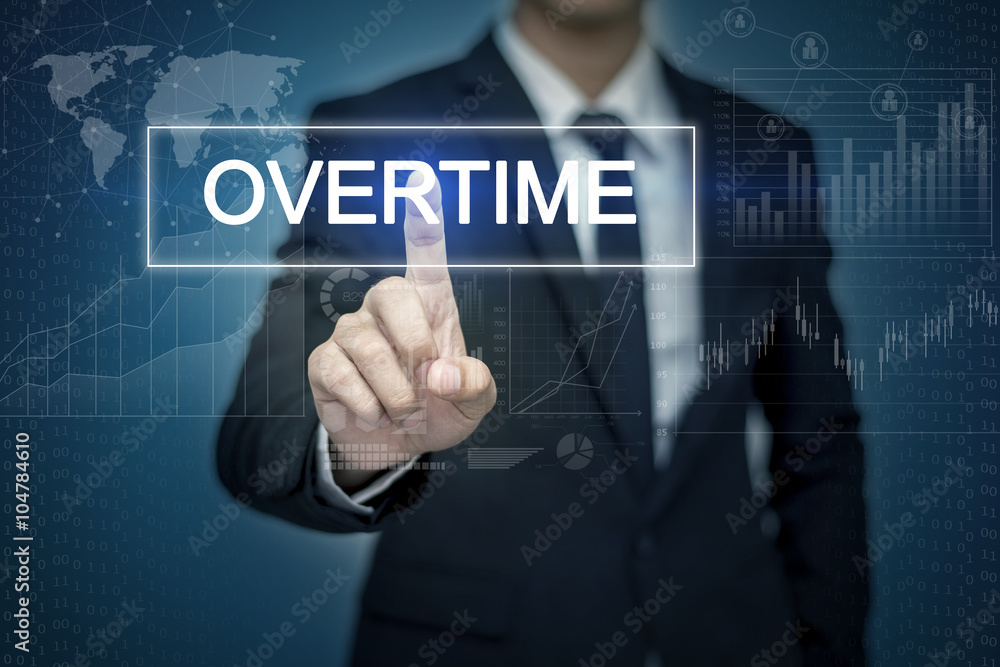 Businessman hand touching OVERTIME  button on virtual screen