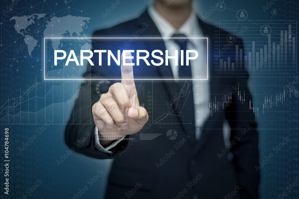 Businessman hand touching PARTNERSHIP button on virtual screen Businessman hand touching PARTNERSHIP button on virtual screen