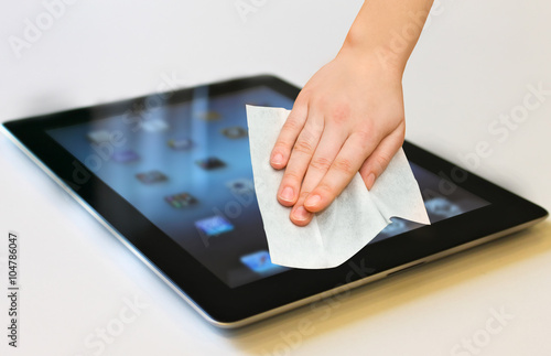 hand with white wet wipe tablet cleaning