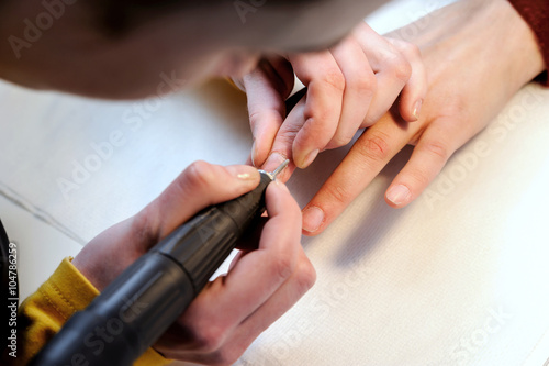 Hardware manicure in a beauty salon.