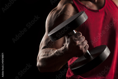 muscular man in red shirt posing with weights