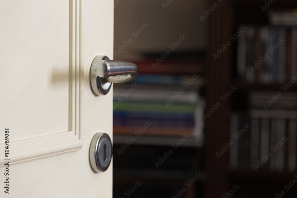 Obraz premium open and closed white doors close up of handle and keyhole