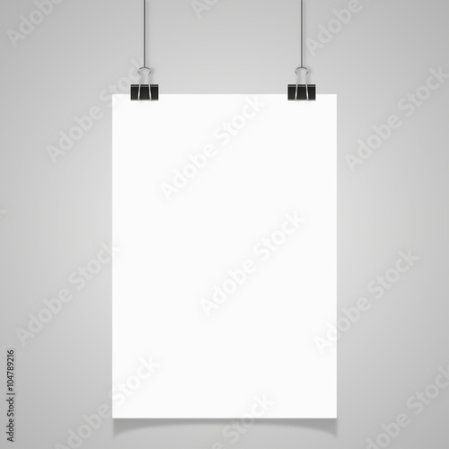 Blank white page hanging against grey background
