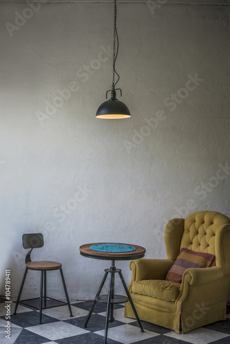 Vintage hipster loft interior with yellow armchair