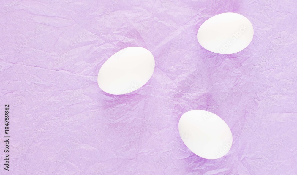 white eggs on a purple background 