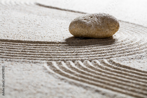 Photography zen sand still-life -single stone on sinuous waves for concept of beauty spa or