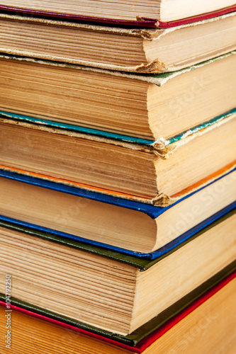 Old books on a wooden shelf.