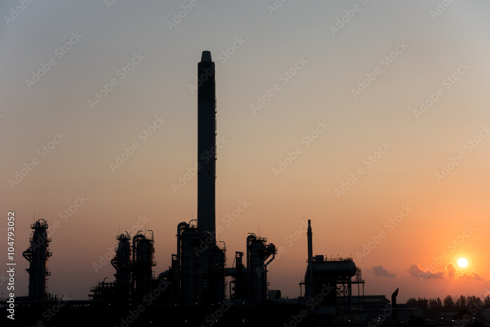 Silhouette Process Columns of Natural Gas Plant with morning sunrise background