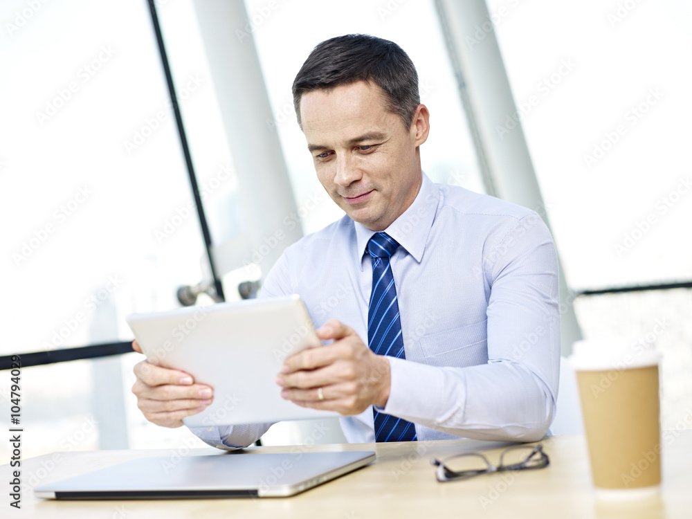 Businessman using tablet in office