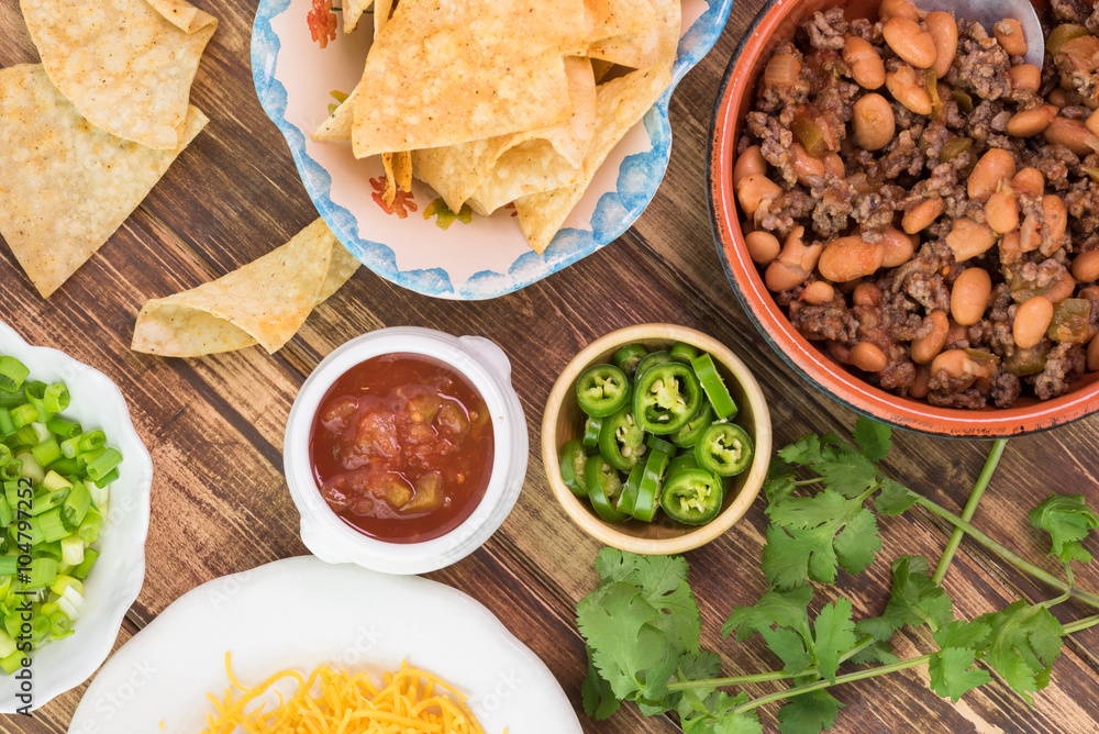 Ingredients for homemade nachos. Bowl with mixed beef and pinto beans. Ingredients for homemade nachos. Bowl with mixed beef and pinto beans.