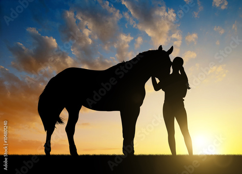 Girl with a horse at sunset. © vencav