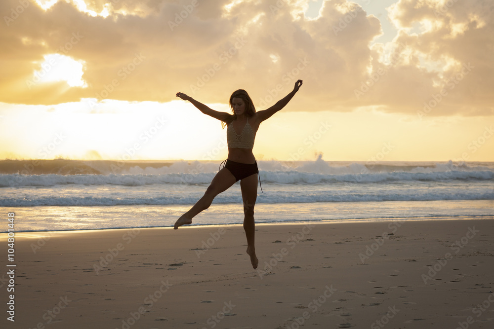 Ballet dancer on beach at sunrise. Ballet dancer on beach at sunrise.