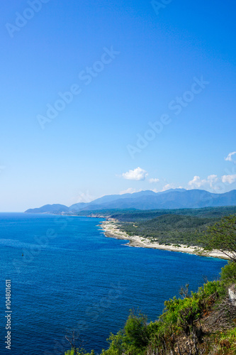 crystal clear sea with the meandering coastline and  tropical landscape © esben468635