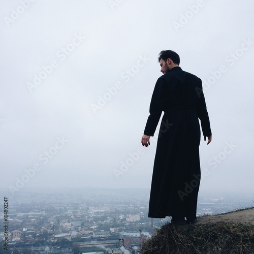 Fototapeta lonely priest on mountains