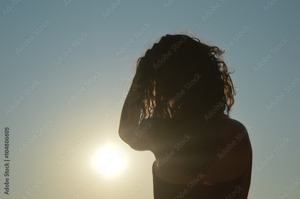 Girl in sunset on beach longing - obrazy, fototapety, plakaty 