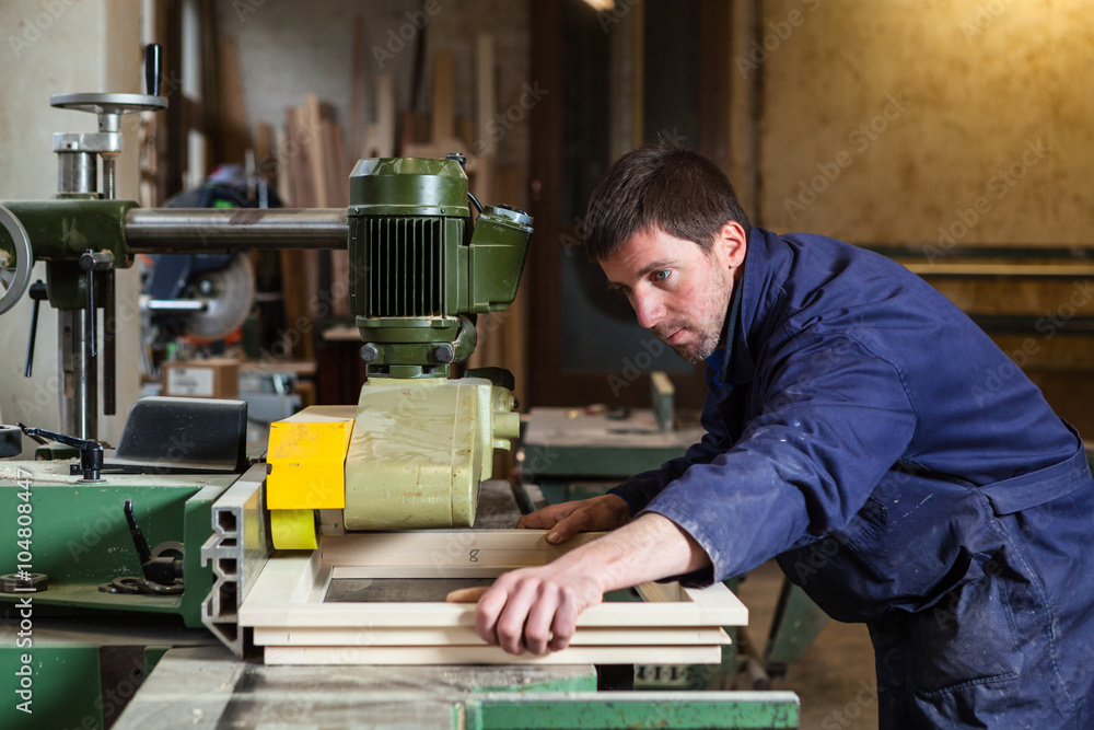 Carpenter man working with tablesaw in workshop Carpenter man working with tablesaw in workshop