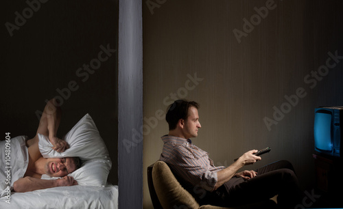 Man at night can't fall asleep because of the noisy neighbor
