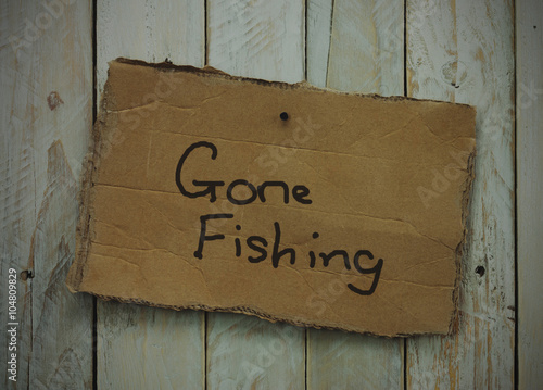 Cardboard sign on a wooden background