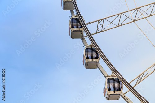 Ferris Wheel on blue sky background.